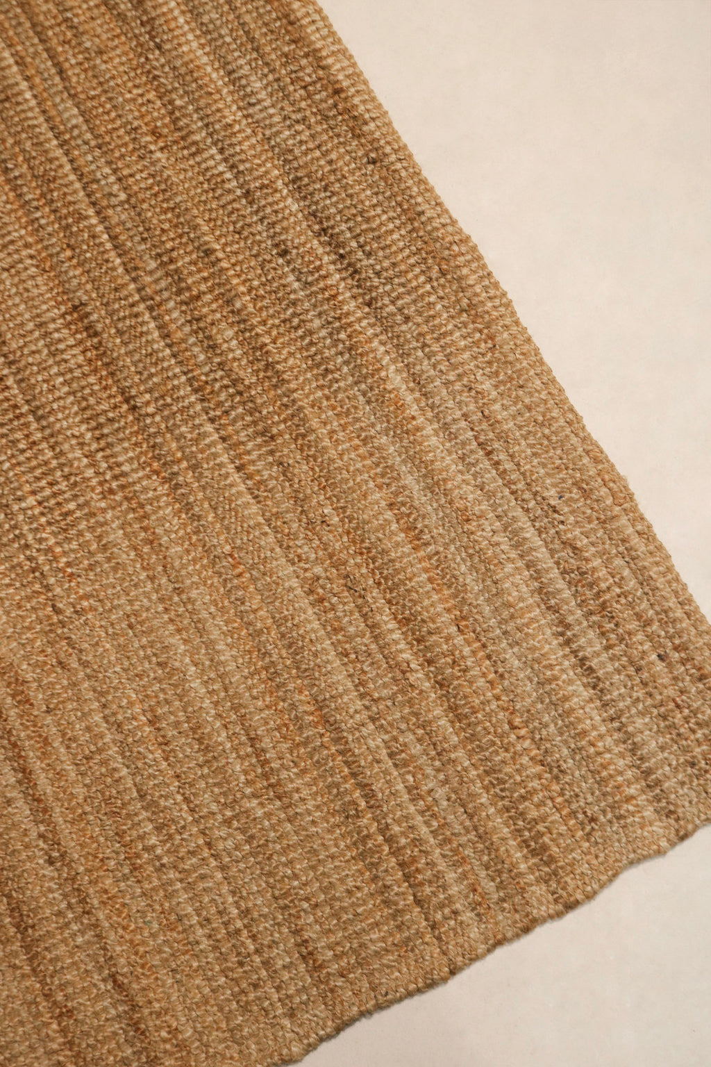 Texture detail of the jute fibers in the rug, highlighting durability and rustic appeal