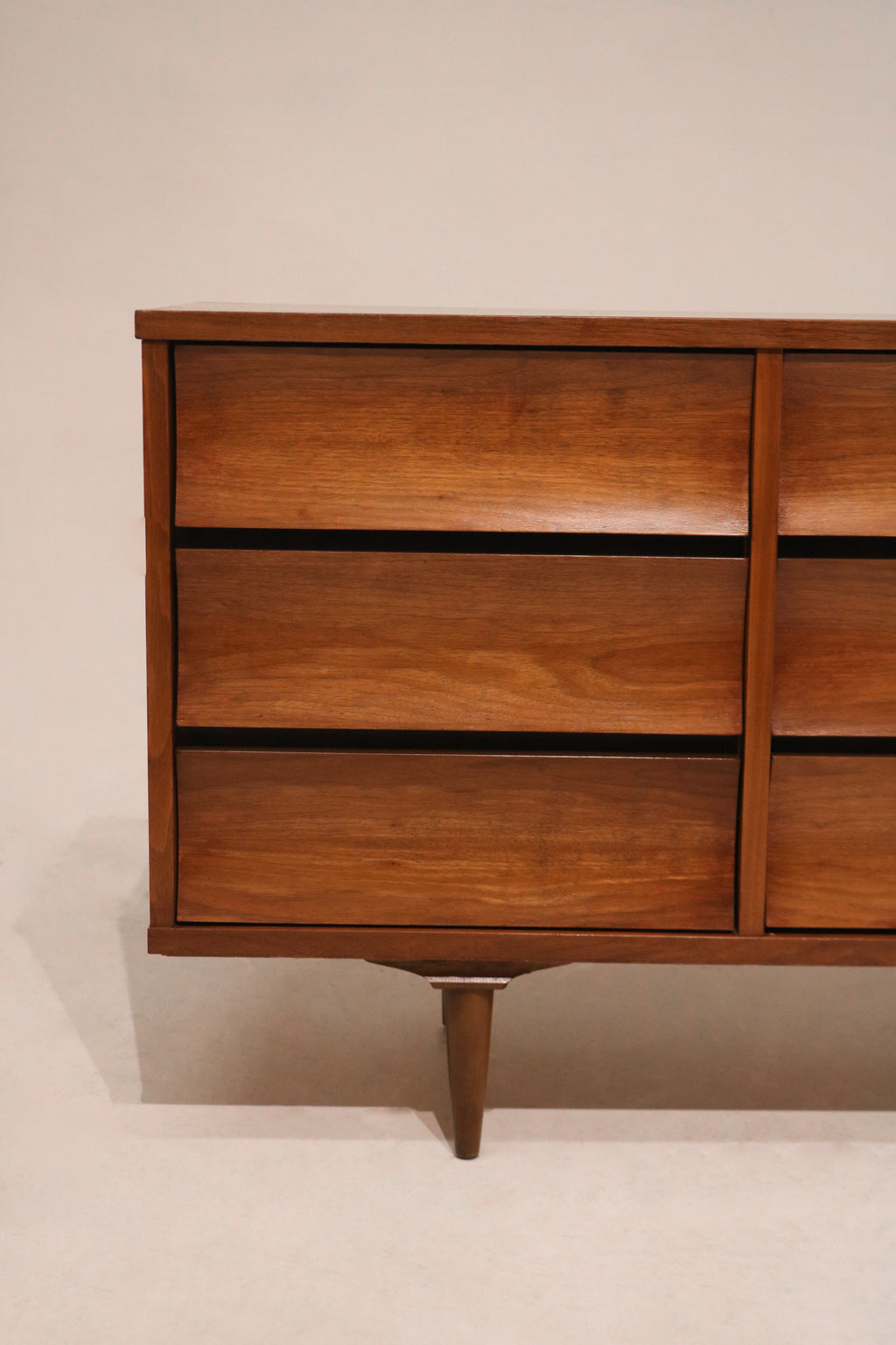 Detailed close-up showing walnut wood grain texture on dresser drawer front