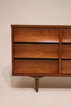 Detailed close-up showing walnut wood grain texture on dresser drawer front