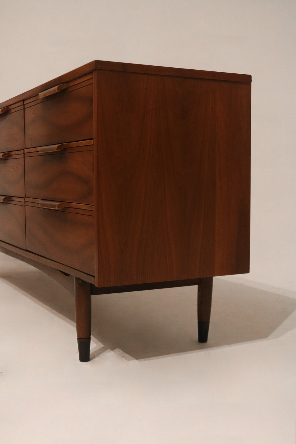 Low-angle photo capturing dresser’s leg design and base clearance