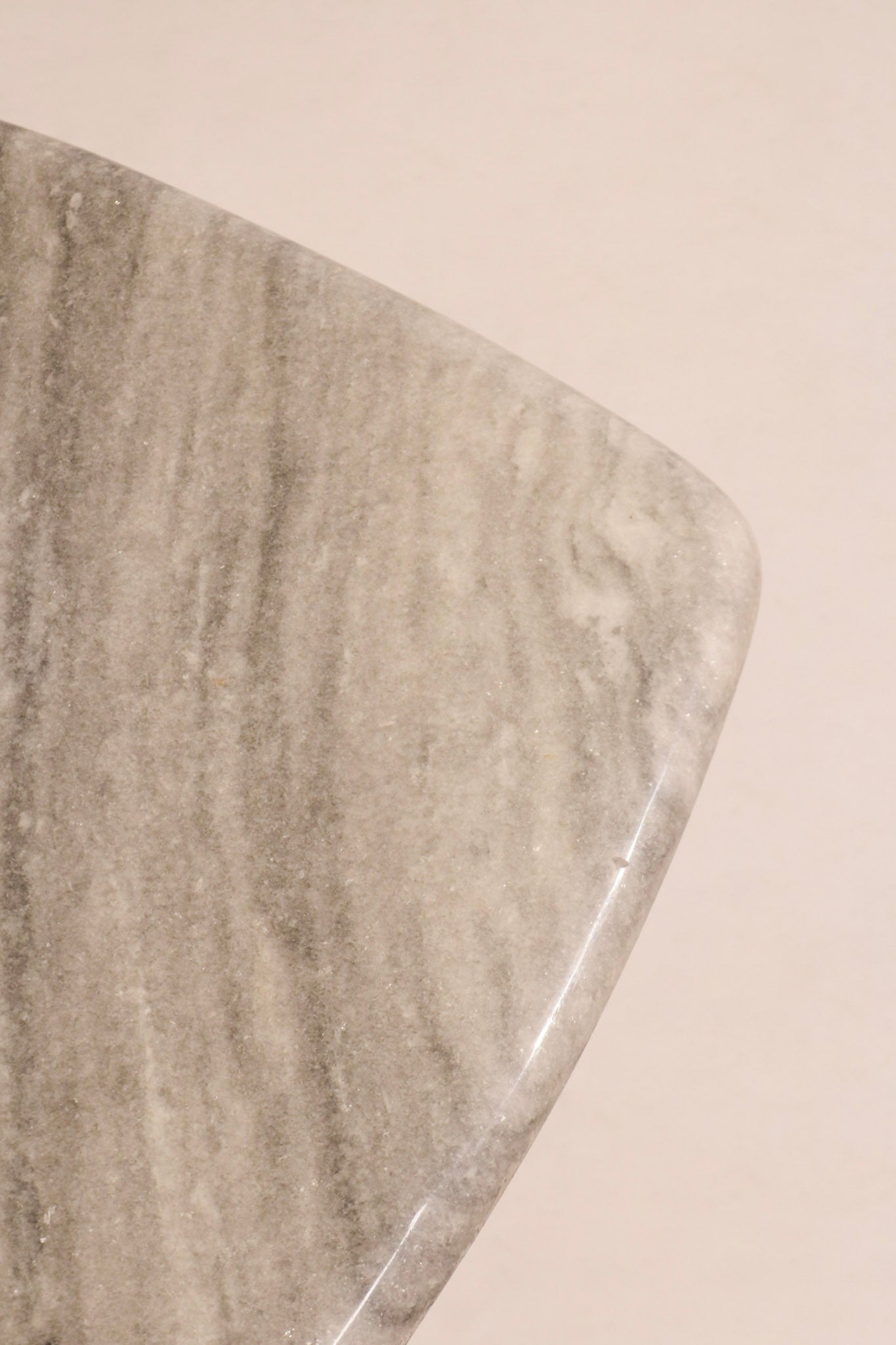 Bottom view showing table’s solid marble construction and finishing details