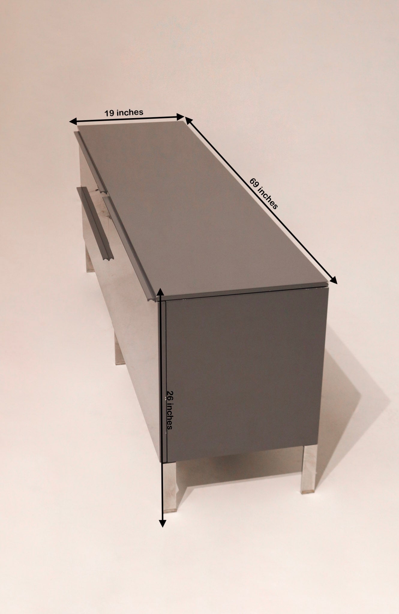 Size diagram showing dimensions of the lacquered Capellini TV Unit: 69in L x 19in D x 26in H