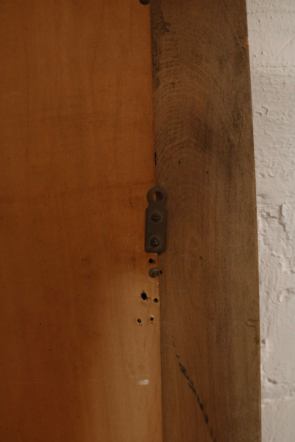Back view showing oak wood frame thickness, backing board, wall-mount hardware, condition of screws and fasteners.