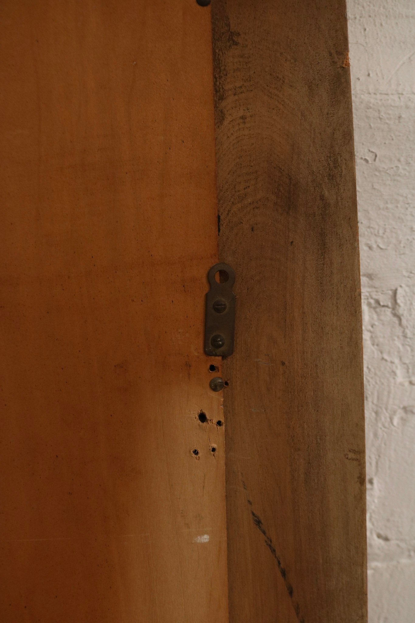 Back view showing oak wood frame thickness, backing board, wall-mount hardware, condition of screws and fasteners.