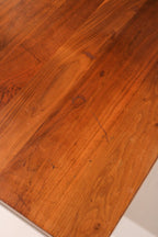 Corner view showing the meeting point of wood top and steel leg for design contrast