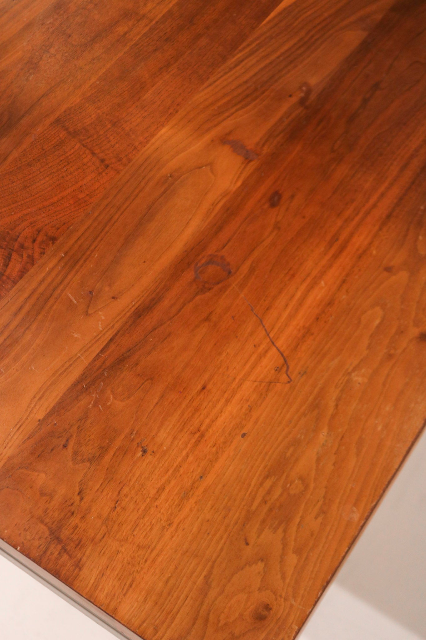 Corner view showing the meeting point of wood top and steel leg for design contrast