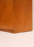 Back view of oak bookcase showing construction and support details in natural wood tone