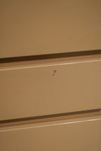 Detailed view of left side panel with subtle chips on the lacquered wood finish