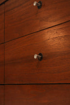 Detailed view of solid wood drawer construction highlighting dovetail joints and natural walnut tones