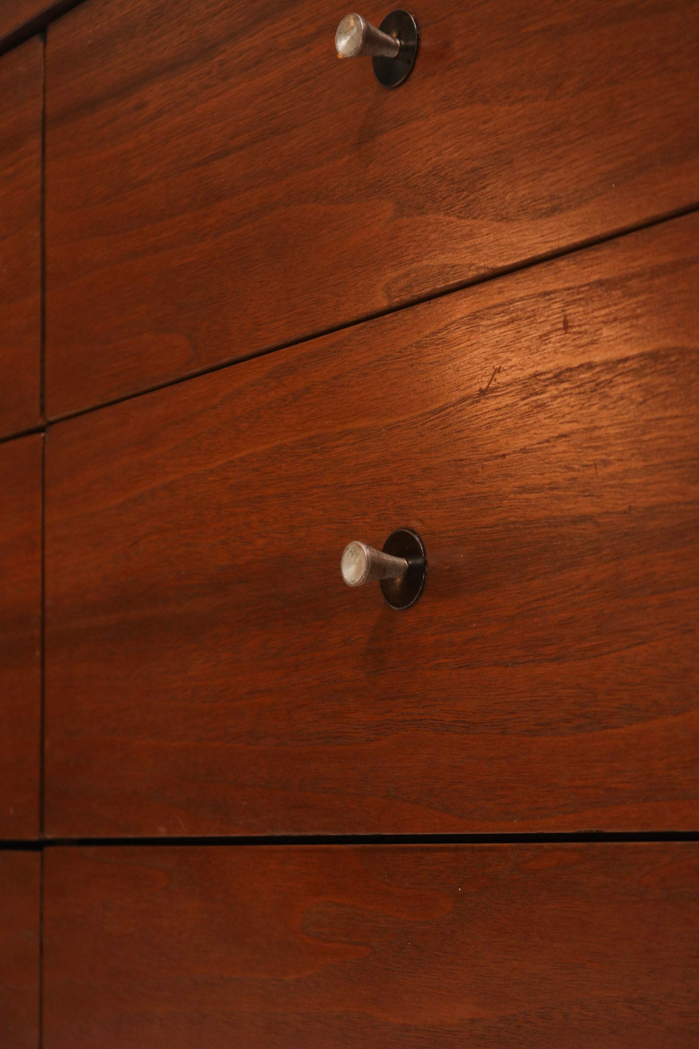 Detailed view of solid wood drawer construction highlighting dovetail joints and natural walnut tones