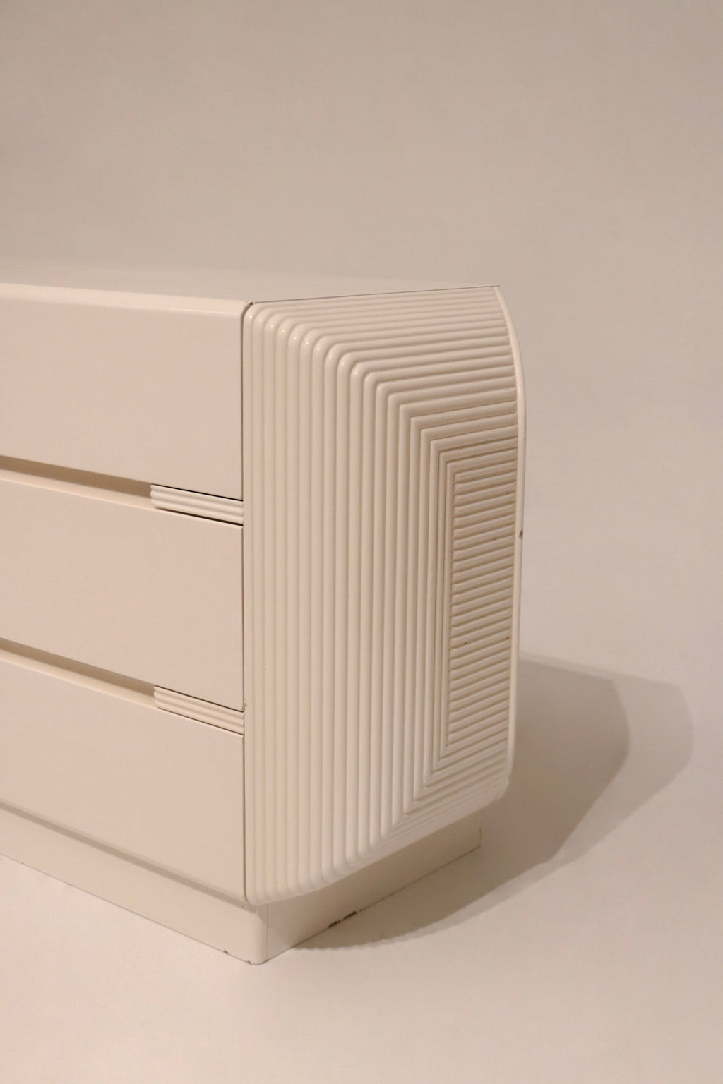 Close-up of lacquered wood surface highlighting glossy white postmodern finish