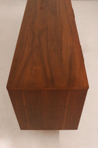 Close-up of walnut wood grain and vintage patina on top surface of MCM dresser