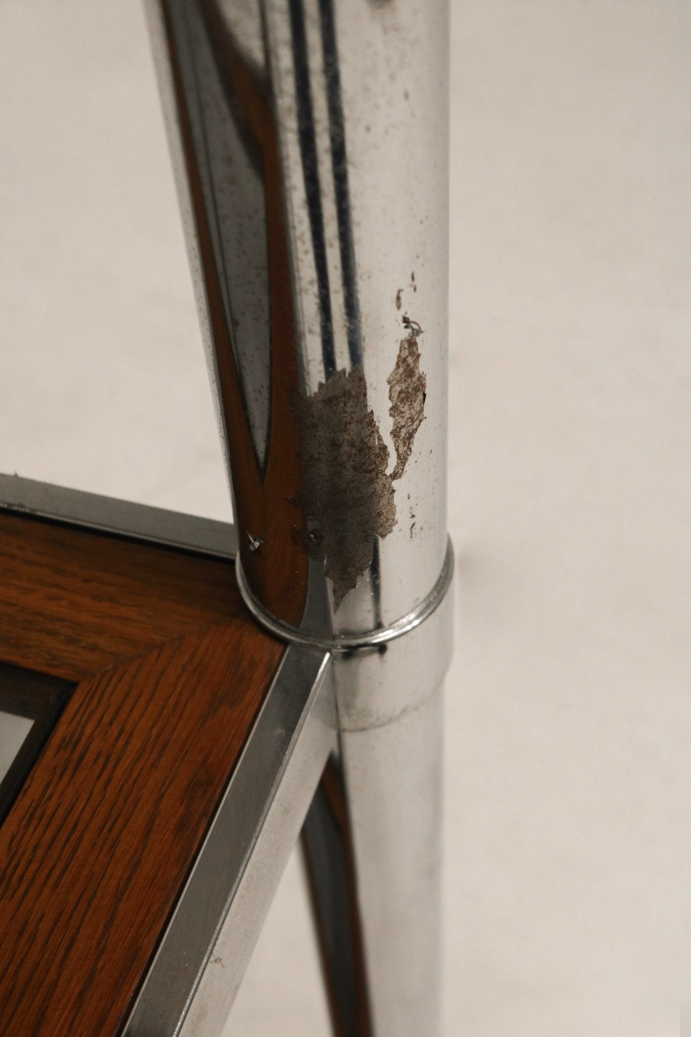 Top corner detail of chrome and wood construction showing joint quality and vintage design