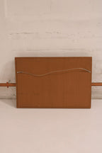Close-up of golden wooden frame corner detailing, highlighting vintage craftsmanship and texture