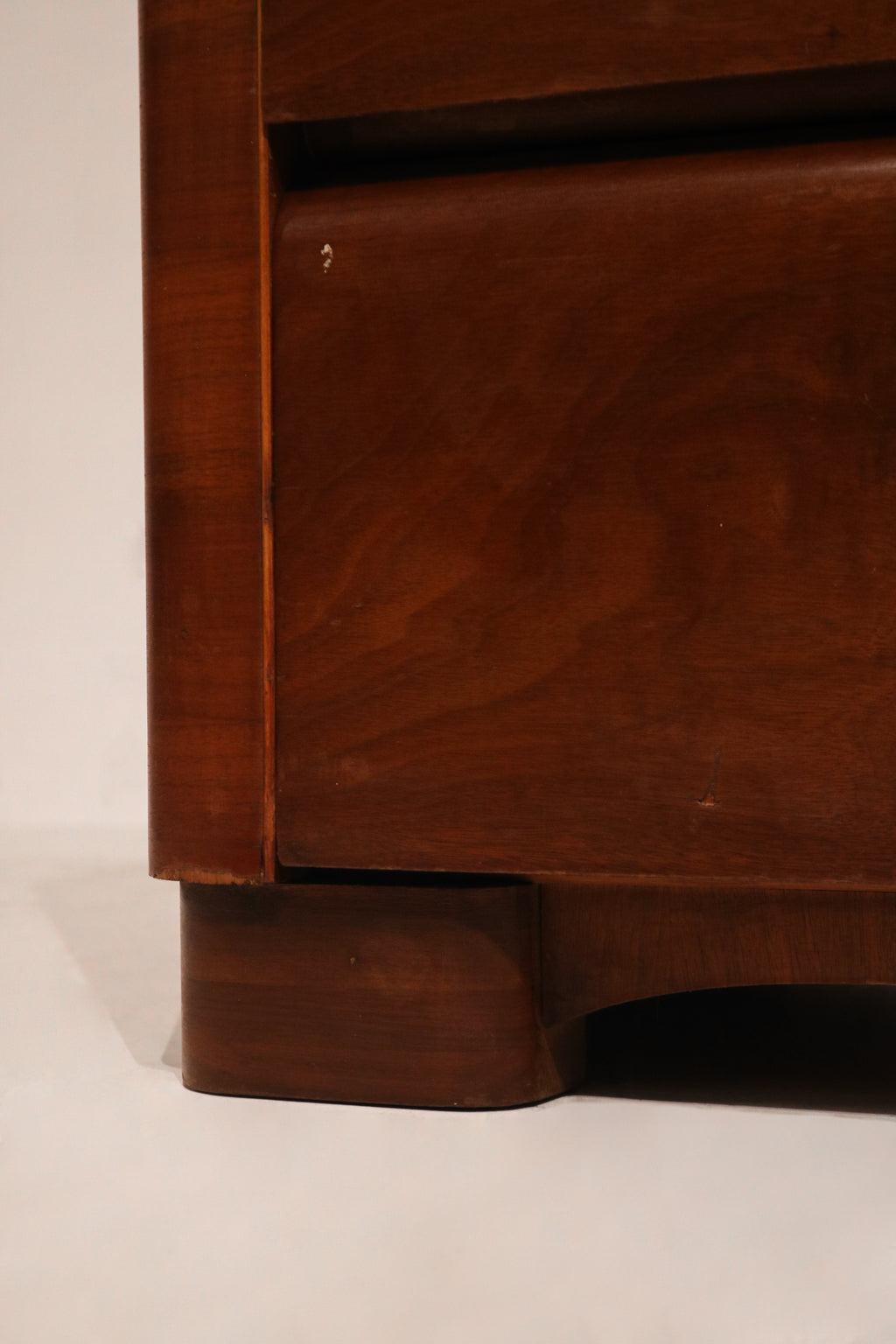 Side angle of Art Deco style dresser highlighting wood veneer and structural design