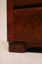 Side angle of Art Deco style dresser highlighting wood veneer and structural design