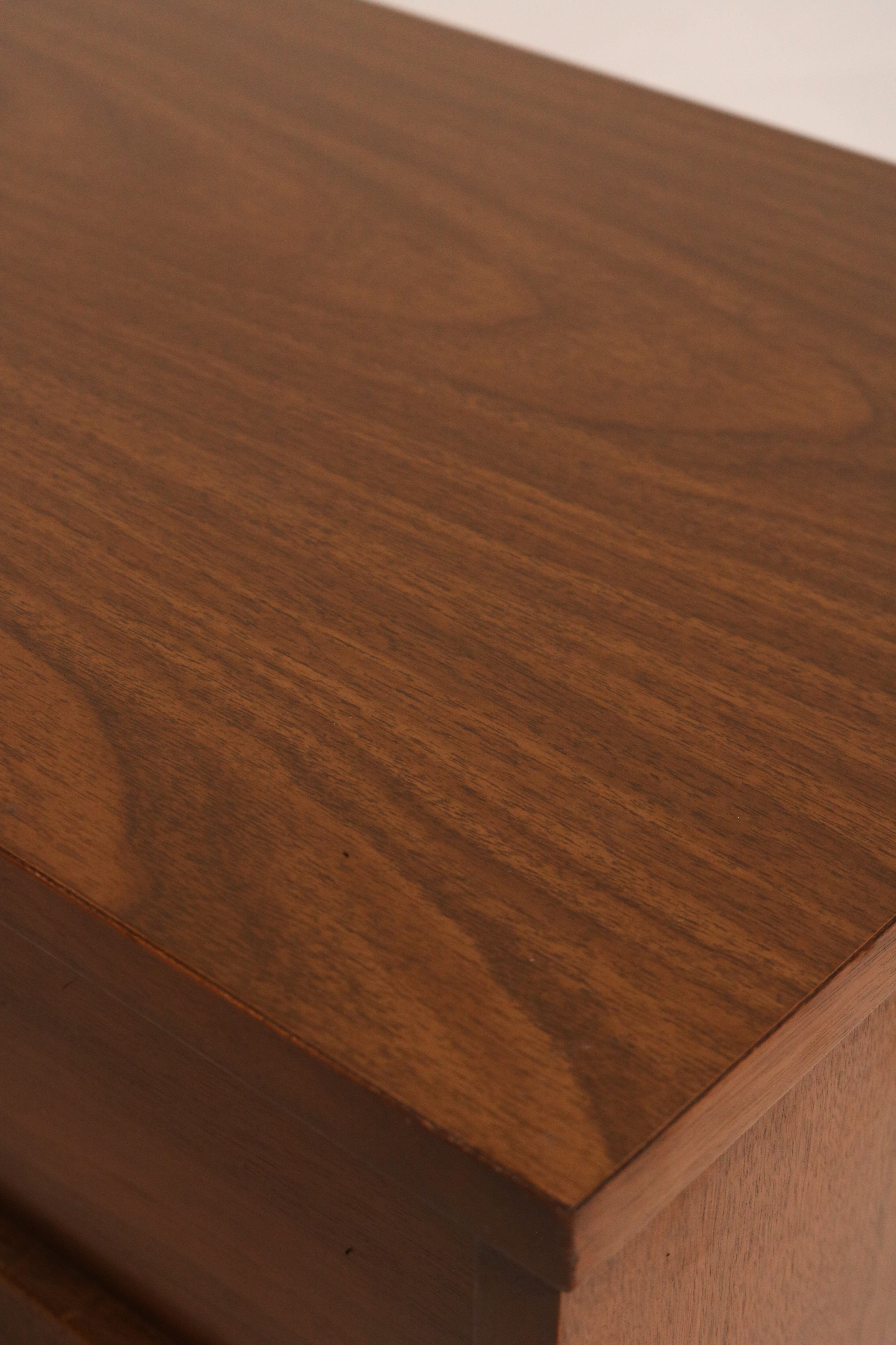 Close-up of light surface scratches on veneer top of walnut bedside table