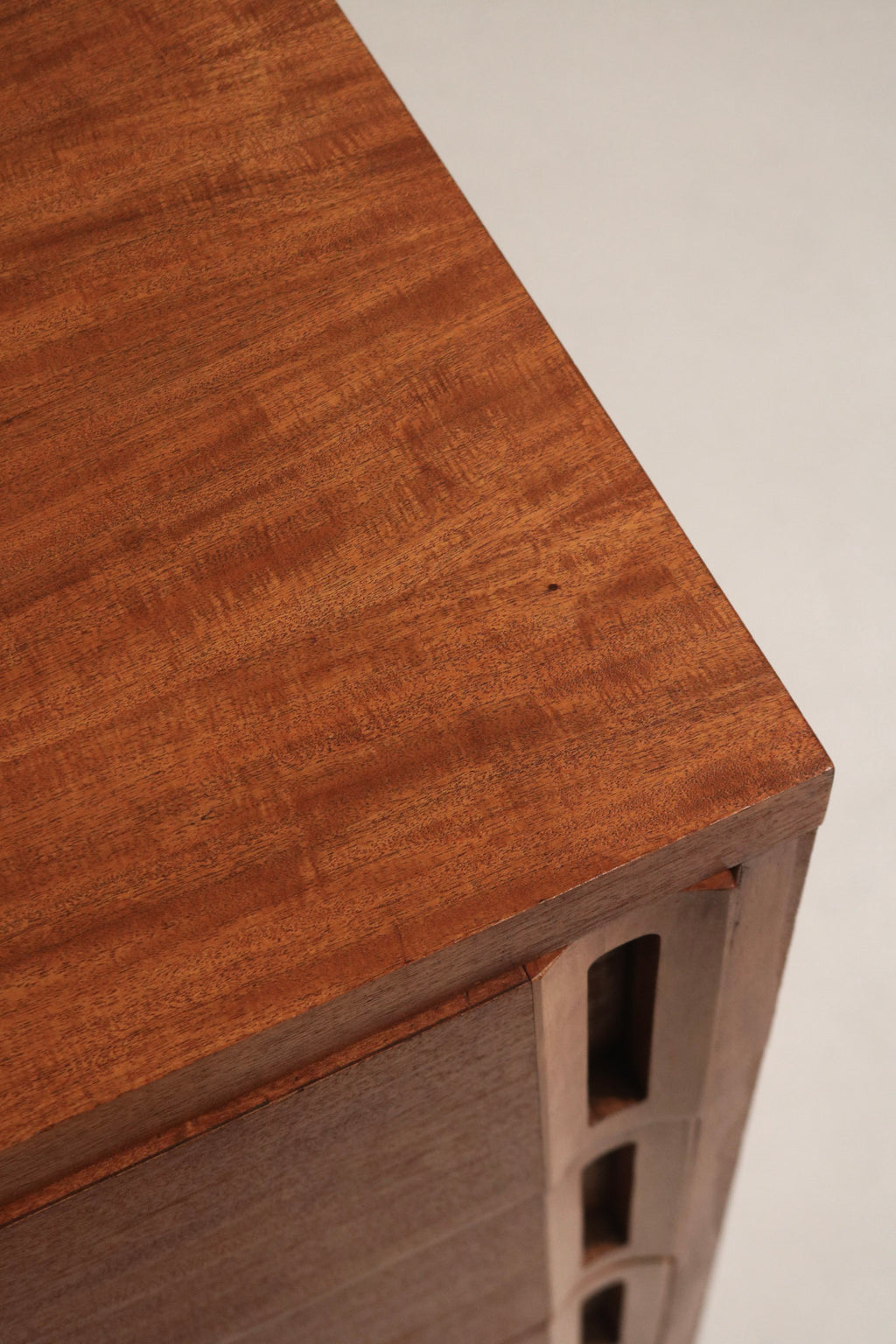 Close-up of stained walnut top surface on vintage solid wood dresser, sanded finish highlighting natural wood grain and subtle patina