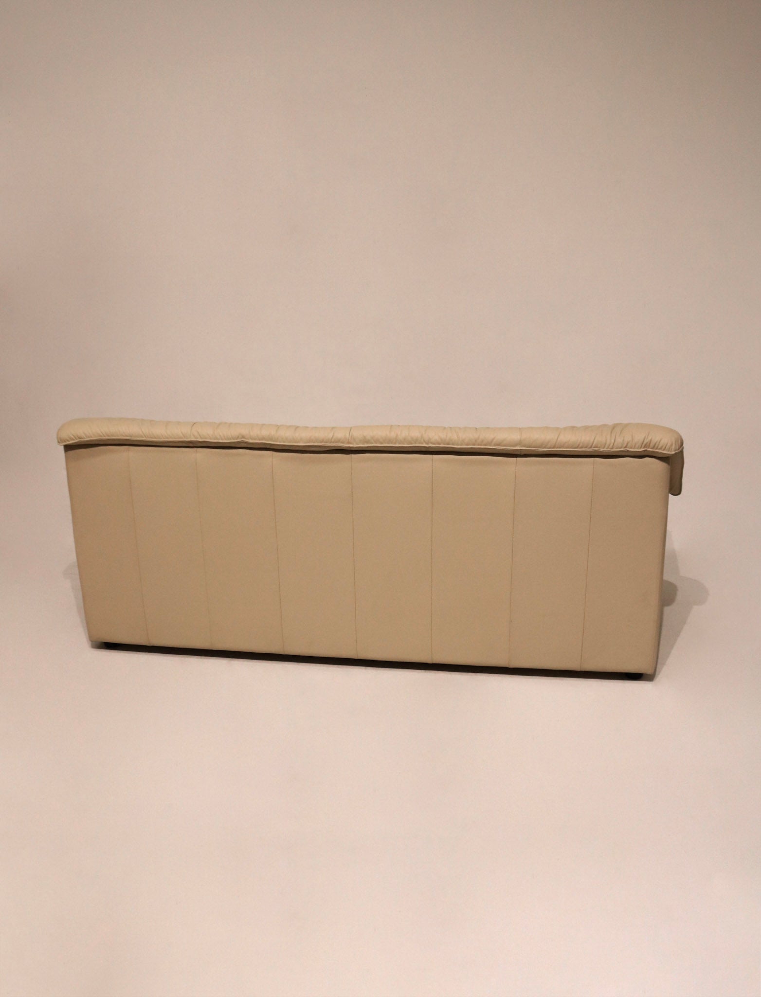 Close-up of beige Italian leather texture on Vintage Sofa Couch, high-quality smooth finish