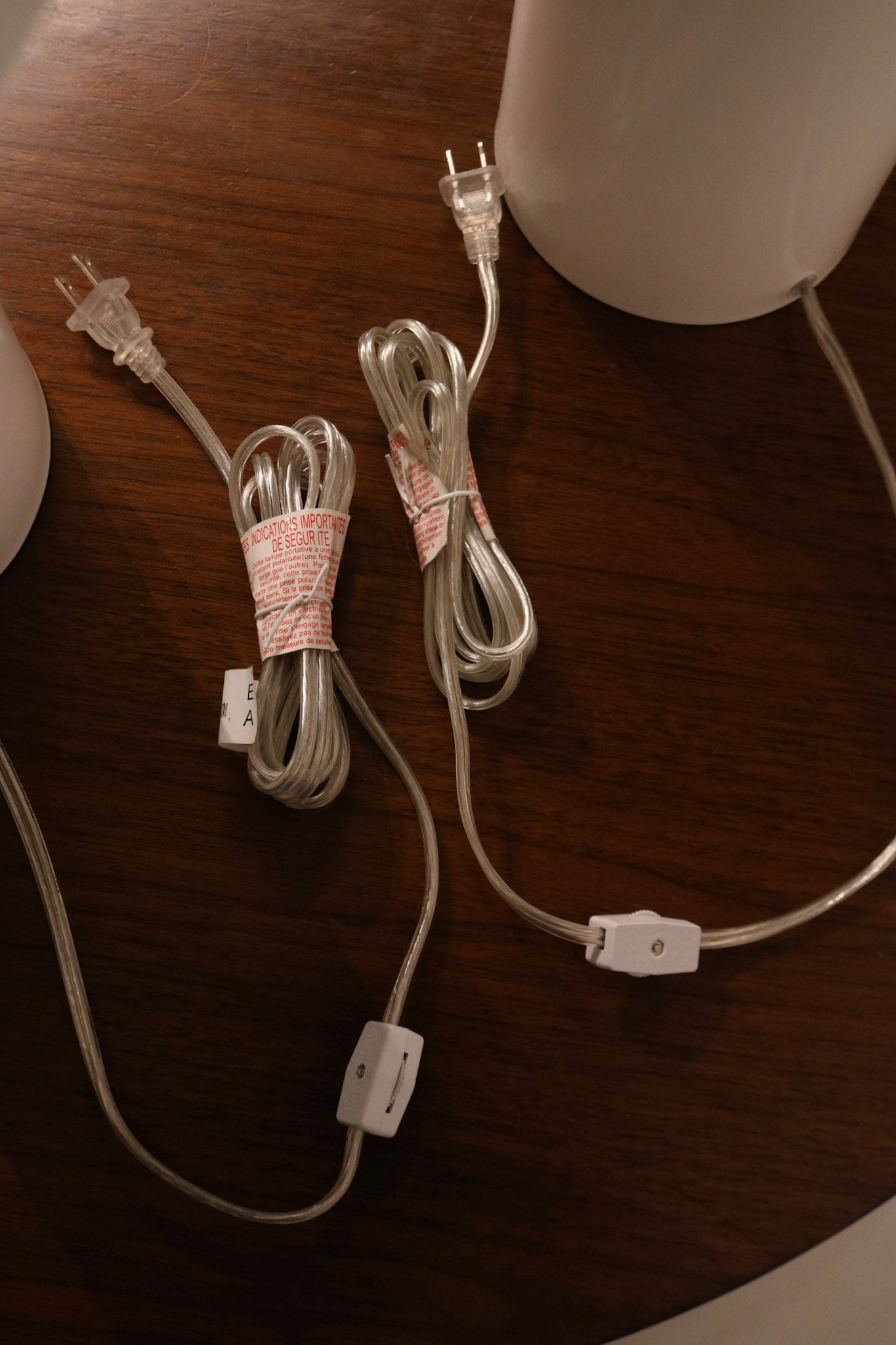 Detail of metal lamp base in white showing seamless construction and slight reflective surface