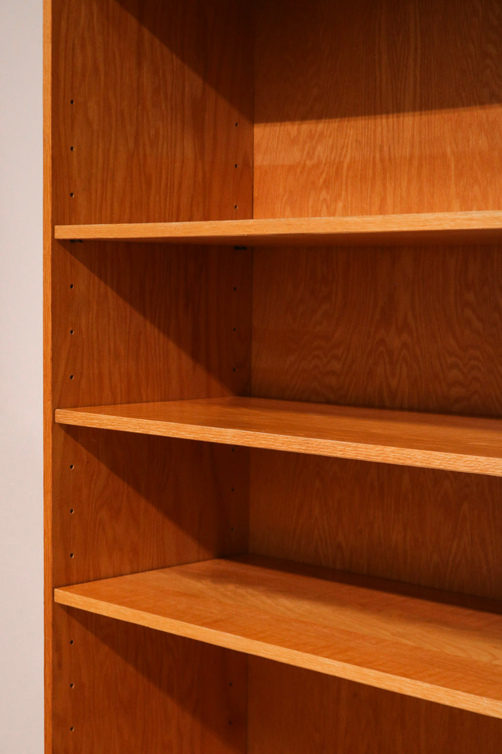 Top edge detail of the Mcm tall bookcase showing craftsmanship and oak wood color