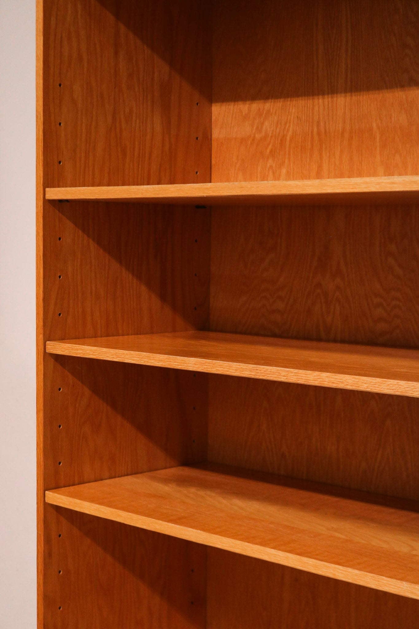 Top edge detail of the Mcm tall bookcase showing craftsmanship and oak wood color