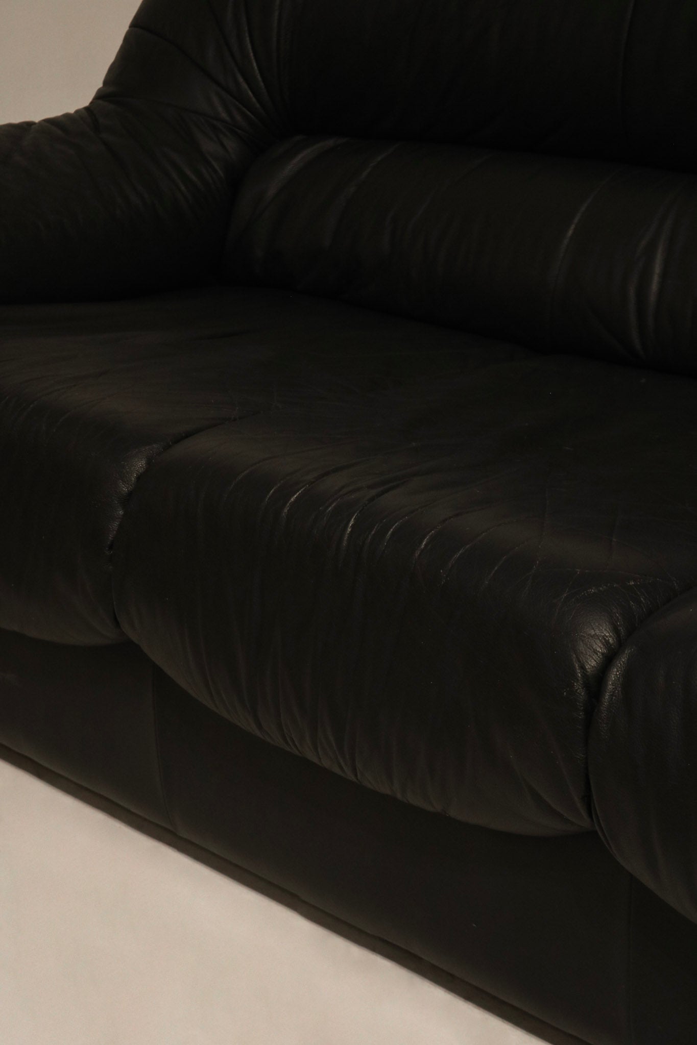 Zoomed-in view of leather grain on the Italian sofa, showcasing texture and dark brown color