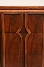 Close-up of original brass hardware on the drawer of walnut wood vintage dresser