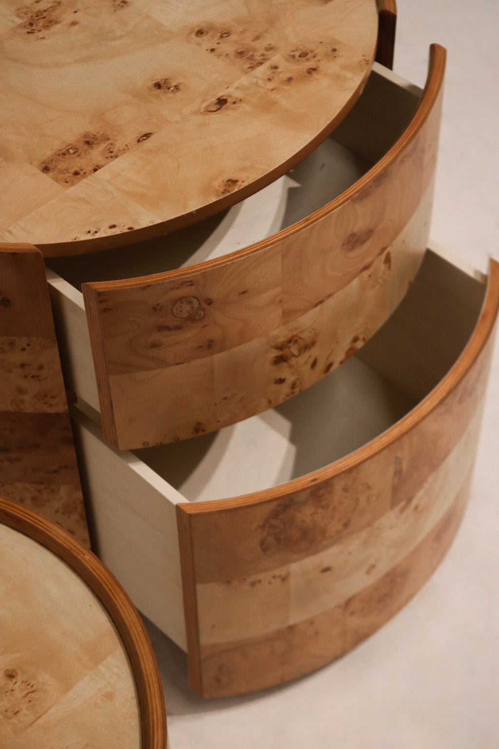 Zoom-in on bottom drawer's push-to-open soft-close feature with seamless wood finish