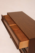 Angled shot of dresser highlighting all six drawers and uniform wood finish