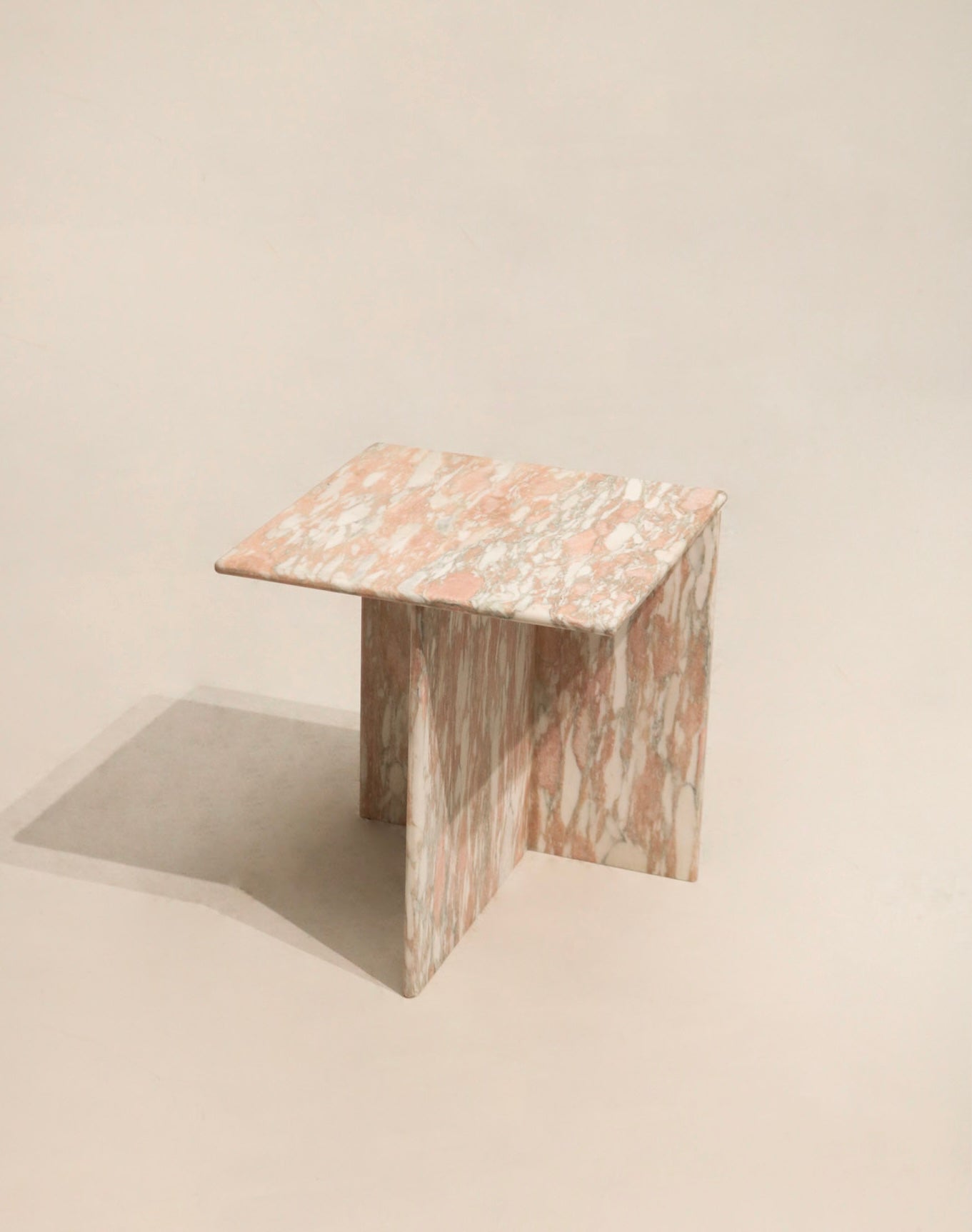 Main view of contemporary natural pink solid marble side end table, polished surface and visible pink veining, 20 x 20 x 22.