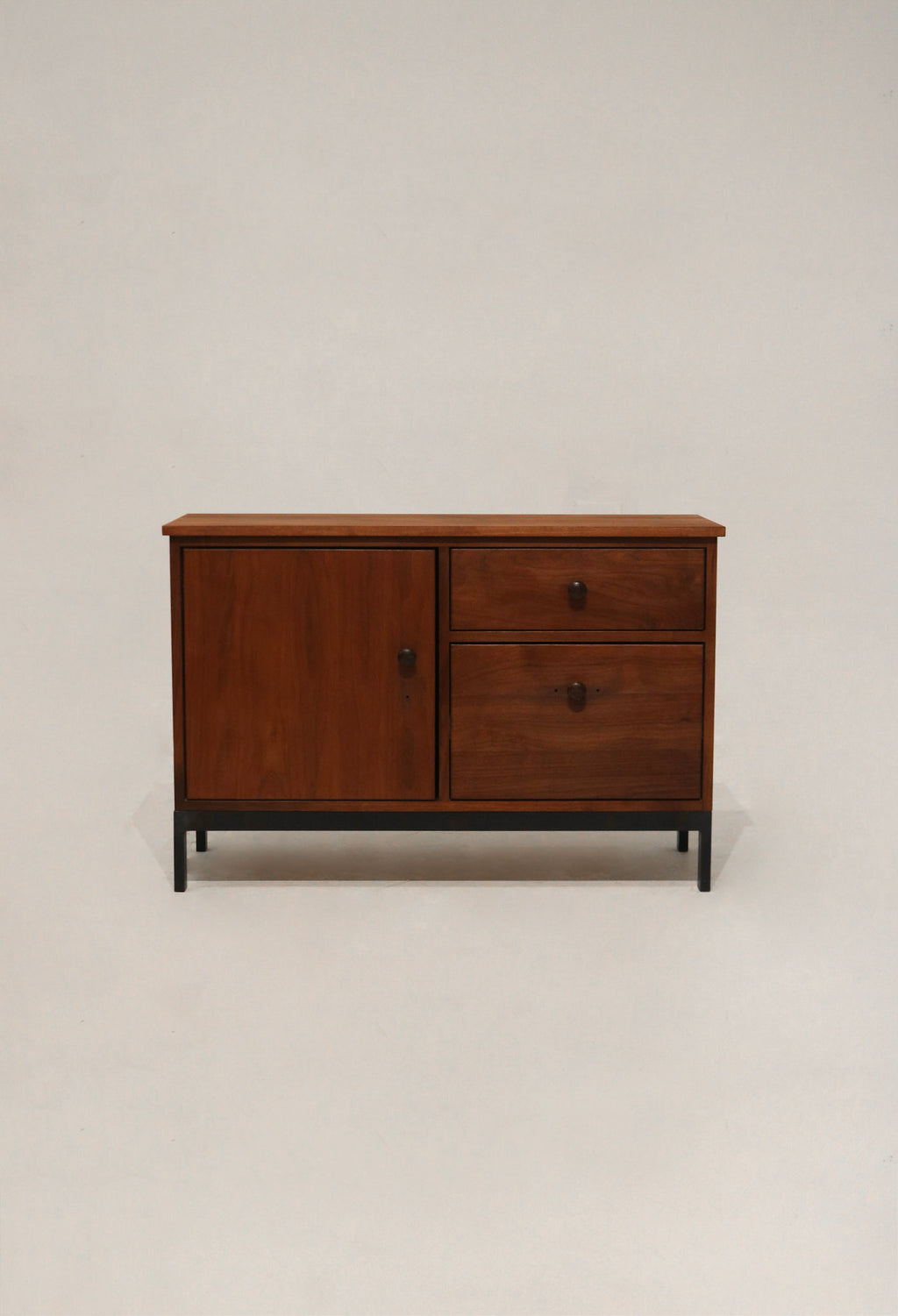 Front view of rustic industrial cabinet made of solid walnut wood with iron legs