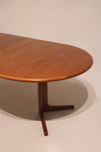 Top-down view of round teak table surface with light reflection on polished wood