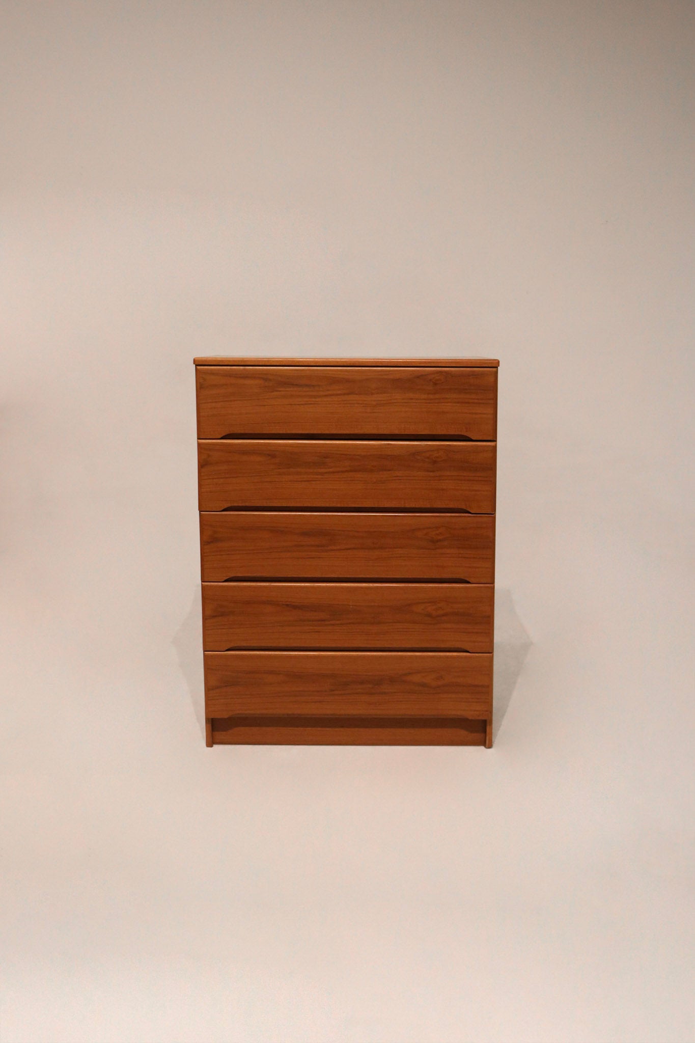 Full view of vintage Danish MCM teak wood 5 drawers dresser with clean lines and warm wood tone