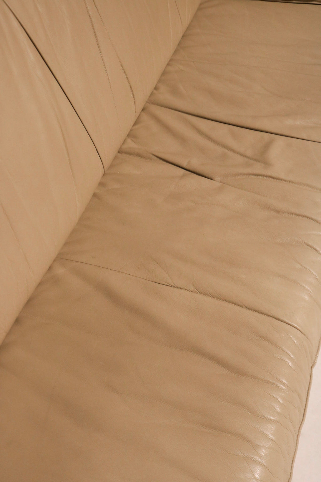 Top-down angle of seating area on beige leather sofa, spacious and immaculate