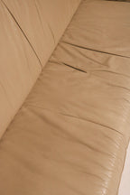 Top-down angle of seating area on beige leather sofa, spacious and immaculate