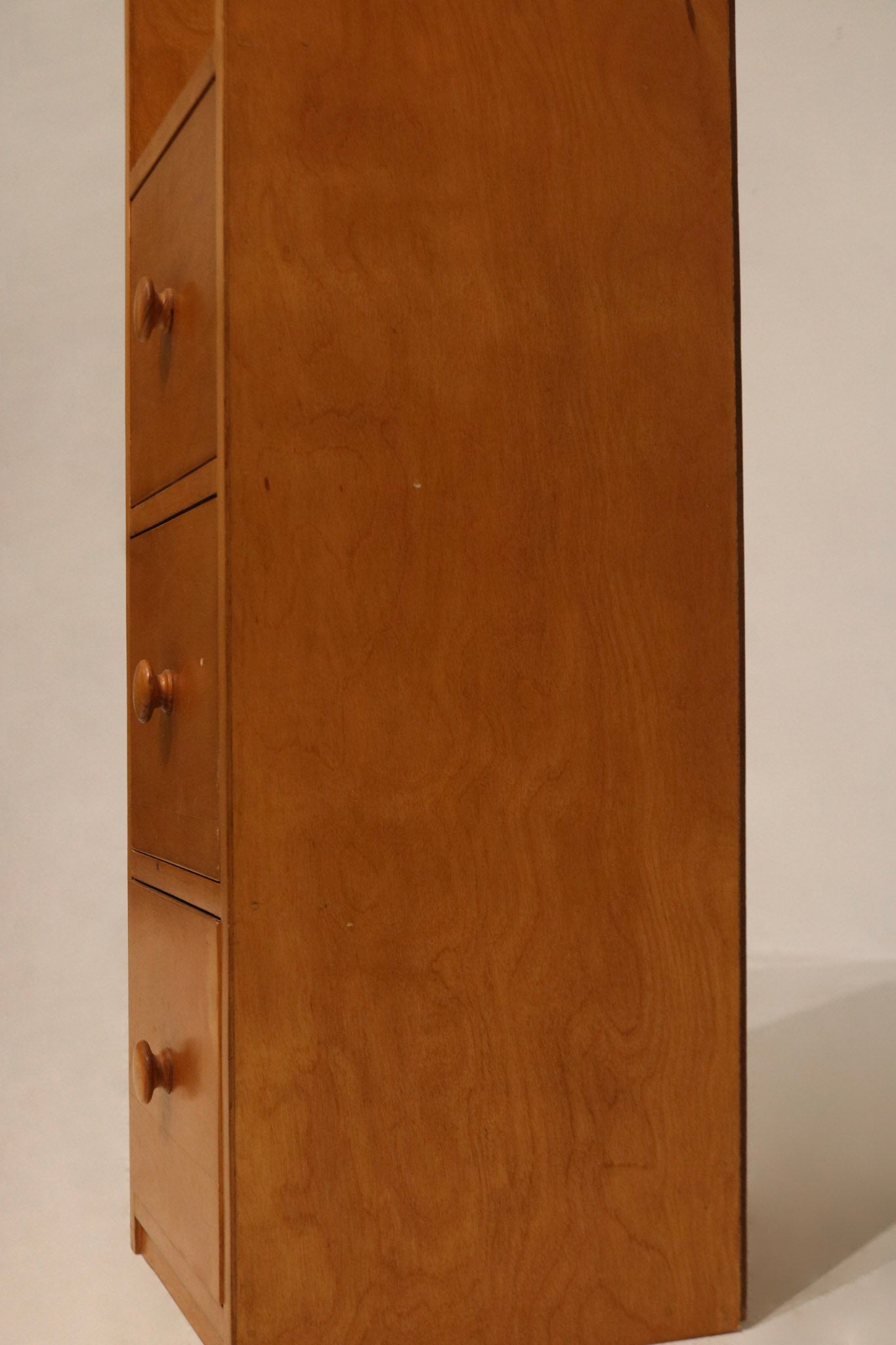 Top-down perspective showing the slim profile of tall oak wood cabinet