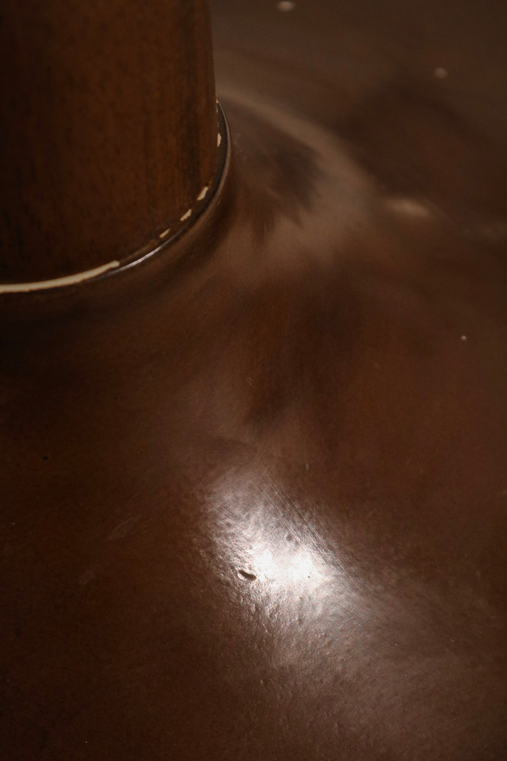 Close-up of table edge showing light chips and overall well-preserved wood surface