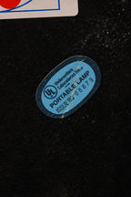 Close-up of chrome steel lamp head with adjustable joint and sleek vintage finish