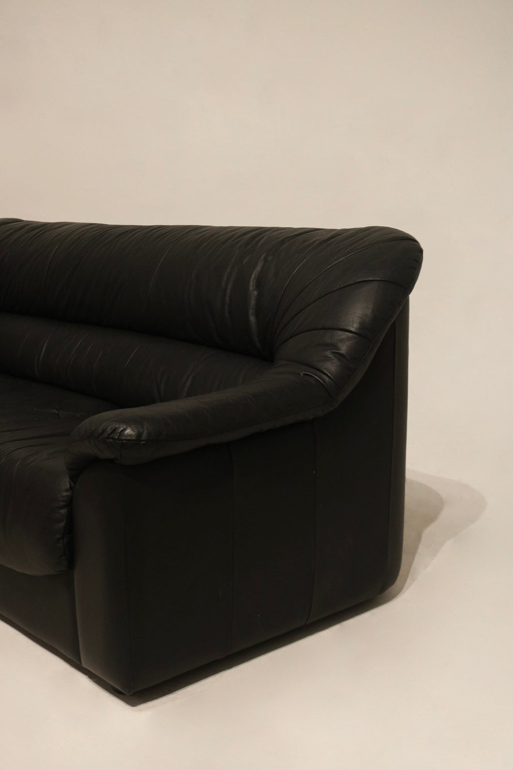 Side angle of the Italian leather sofa showcasing proportions and sleek profile