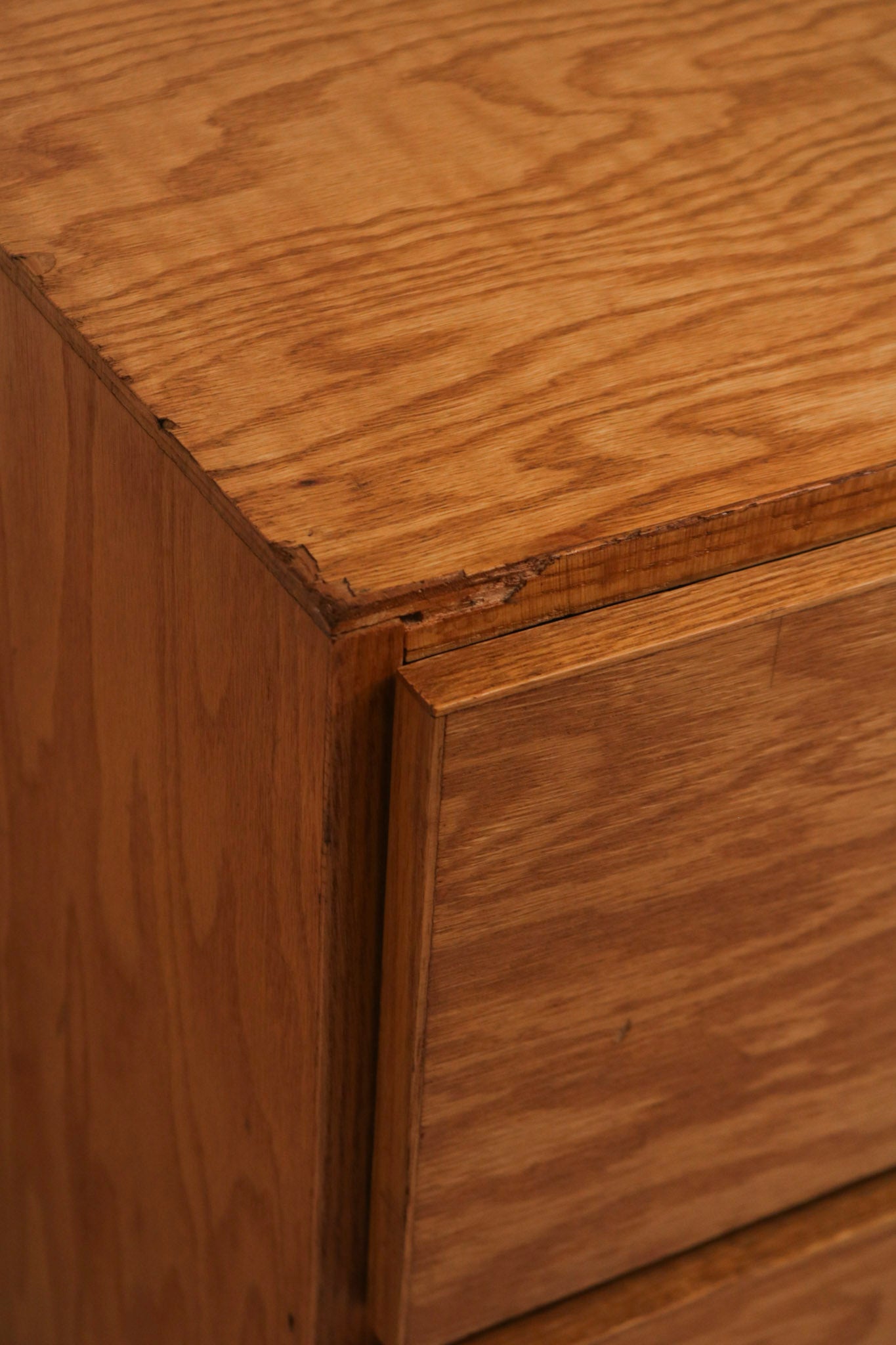 Textured look at dresser front showcasing wood grain patterns and drawer alignment