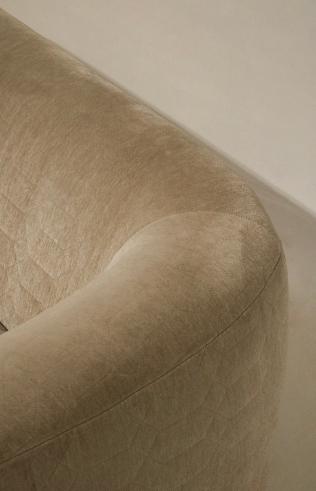 Detail of upholstery stitching and reinforcement, champagne velvet fabric, durable construction at seams and corners for long-lasting use