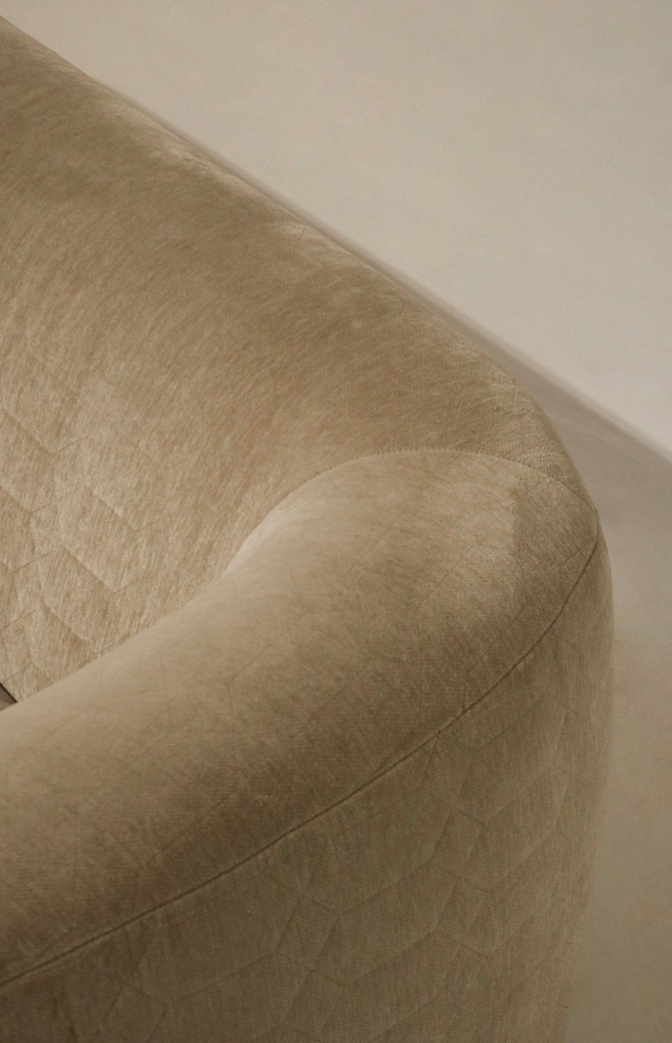 Detail of upholstery stitching and reinforcement, champagne velvet fabric, durable construction at seams and corners for long-lasting use
