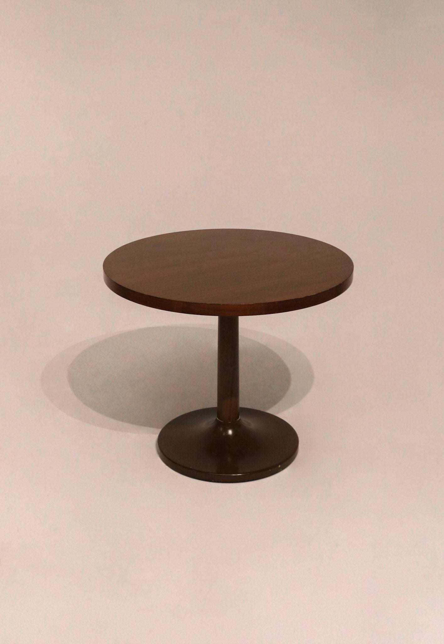 Full view of wooden round bistro dining table showing smooth wood finish and sturdy base
