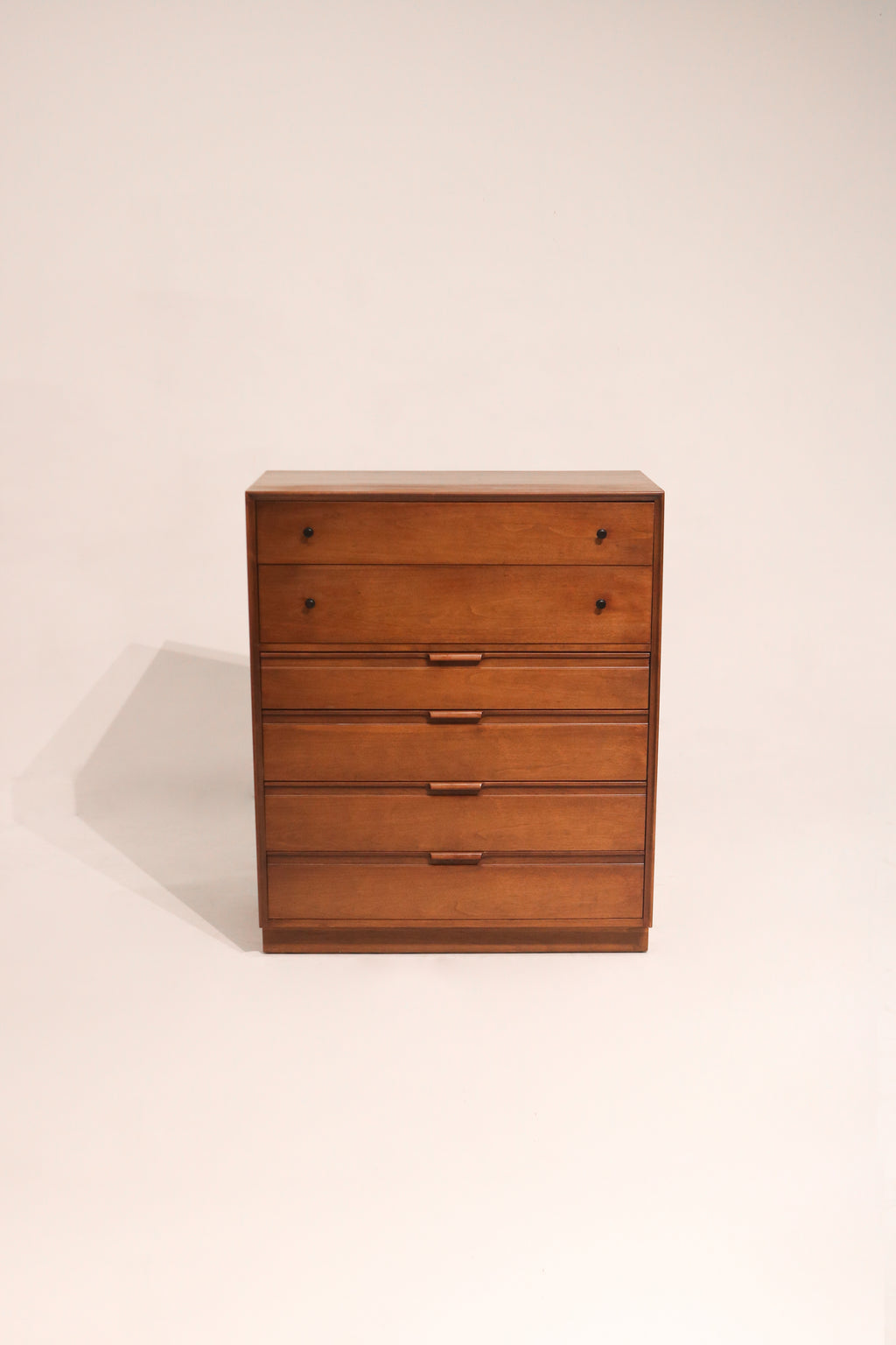 Full view of mid century modern highboy dresser made from solid walnut wood with sleek vertical design