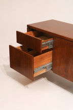 Close-up of hardware pulls, brushed metal handles on solid wood drawers