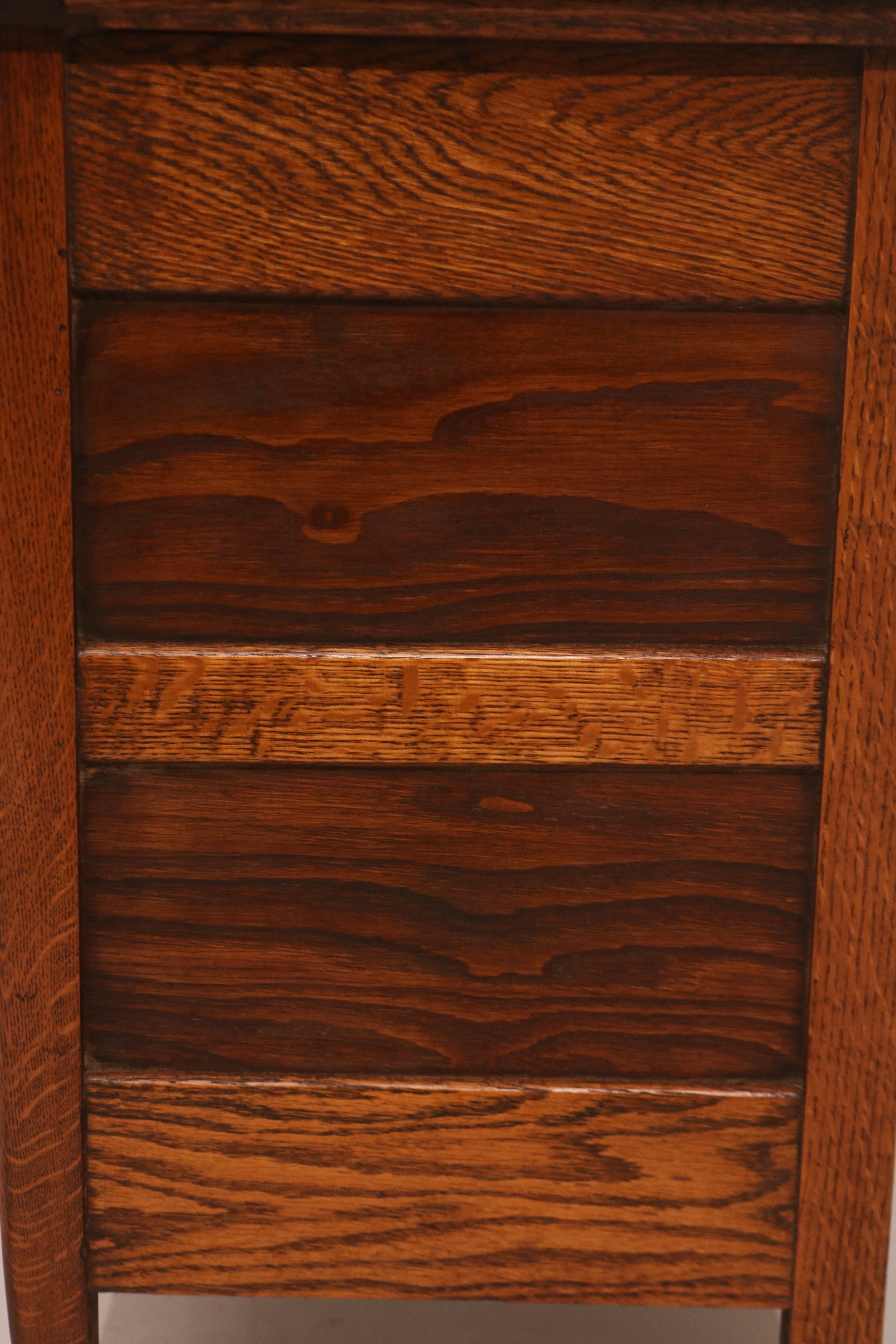 Close-up of drawer fronts showing dark stained oak wood grain