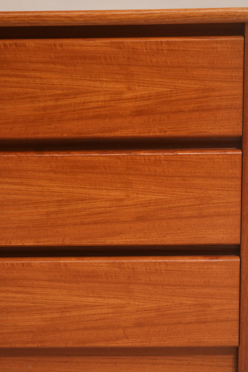 Close-up of drawer fronts showing continuous teak wood grain