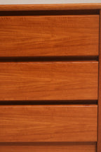 Close-up of drawer fronts showing continuous teak wood grain