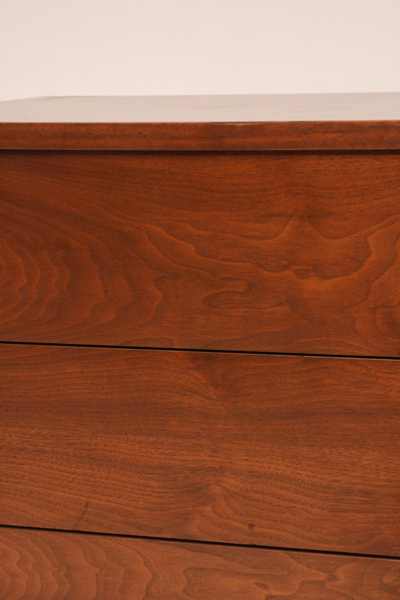 Close-up of drawer fronts showing walnut texture and finish quality